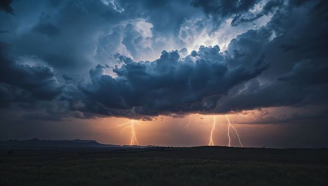 Dramatic lightning storm over grasslands with distant mesas