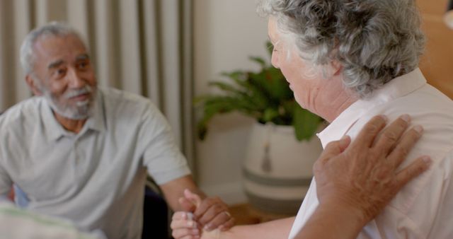 Diverse male and female senior colleagues holding hands in therapy group - Download Free Stock Photos Pikwizard.com