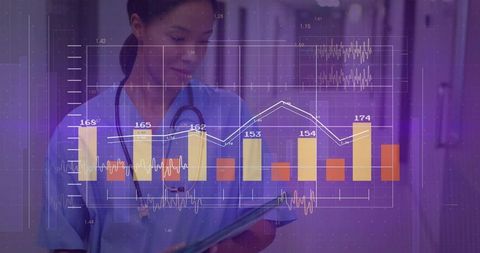 Nurse analyzing data on tablet in hospital corridor