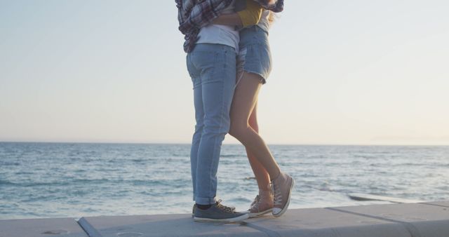 Couple embracing near ocean at sunset - Download Free Stock Images Pikwizard.com