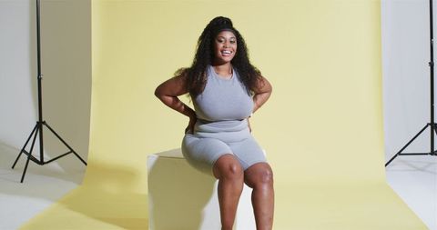 Confident African American Woman Posing in Vibrant Studio