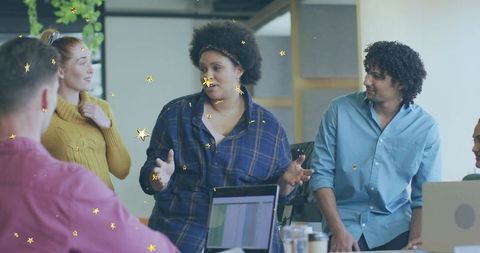 Confident woman leading brainstorming, gesturing during collaborative office meeting