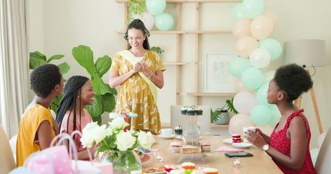 Diverse Friends Celebrating with Cupcakes at Home Gathering