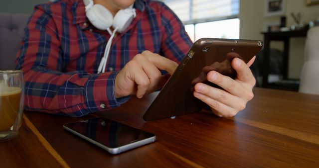 Person Using Tablet While Working or Studying at Home with Smartphone and Coffee - Download Free Stock Images Pikwizard.com