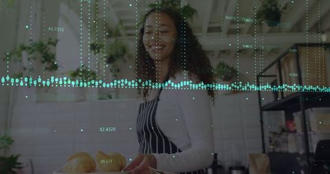 Woman serving fresh pastries in modern cafe setting