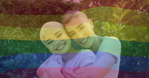 Happy Diverse Female Couple in Pride Flag Overlay Embrace