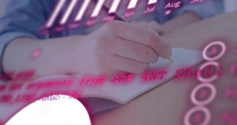 Young Student Writing Amidst Financial Data Interface