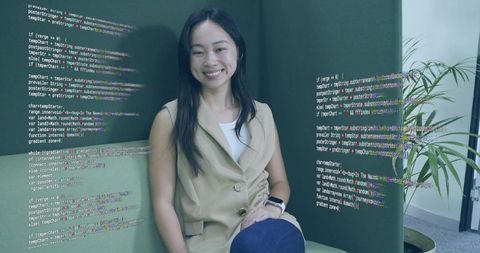 Asian woman in modern office space surrounded by augmented code