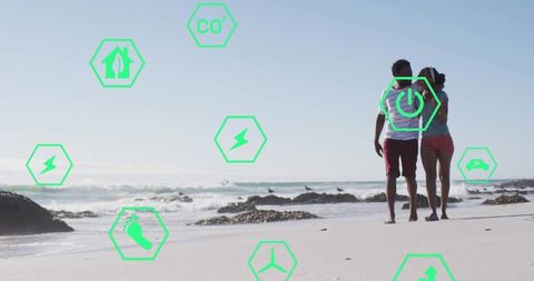 Couple walking along beach with green eco icon overlays promoting sustainable living