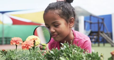 Curious Young Student Exploring Flowers in School Garden