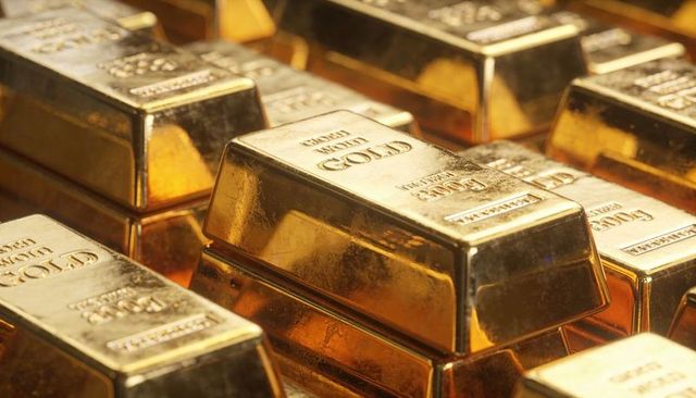 Closeup stacked gold bars gleaming bullion ingots reflecting wealth and finance