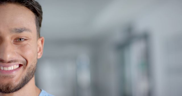 Half Smiling Face of Young Man in Office Setting, Blurred Background - Download Free Stock Images Pikwizard.com