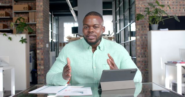 Confident Businessman presenting Financial Report in Modern Office - Download Free Stock Images Pikwizard.com