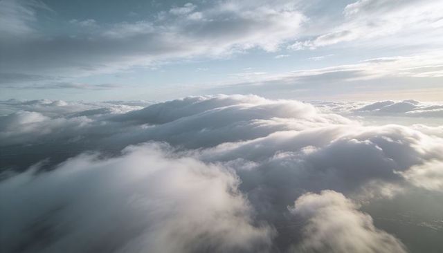 Rolling Cloudscape Unfolding Over Sunlit High-Altitude Skies With Layered Clouds