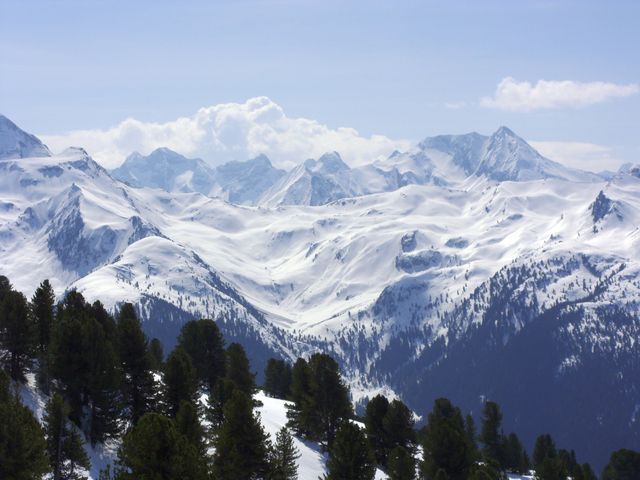 Snow-covered Mountain Range with Pine Trees under Blue Sky - Download Free Stock Photos Pikwizard.com