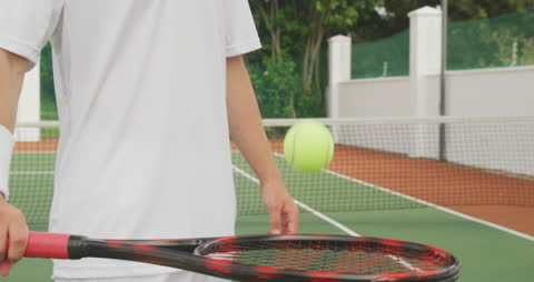 Tennis Player Bouncing Ball on Racket in Practice Session
