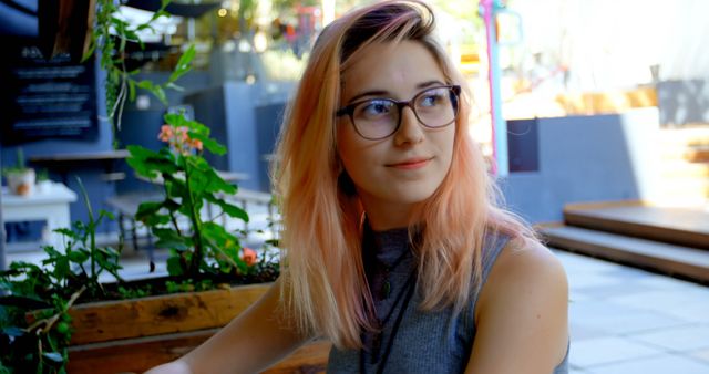 Young Woman With Glasses Sitting in Modern Café - Download Free Stock Images Pikwizard.com