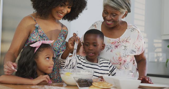 African American grandmother, mother, daughter, and son baking in the kitchen, showing family bonding, joy, and togetherness. Use this for articles and advertisements about family life, cooking, and multi-generational experiences.