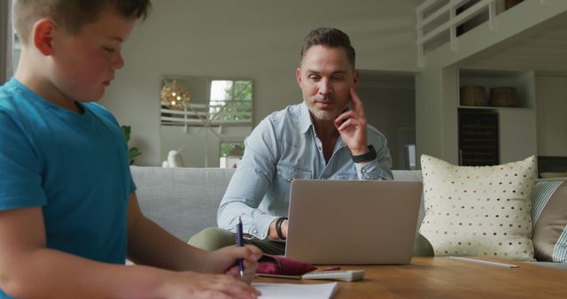 Father Working from Home While Son Doing Homework - Download Free Stock Images Pikwizard.com