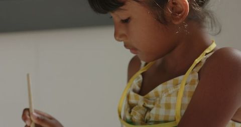 Child focusing quietly on writing task in classroom setting
