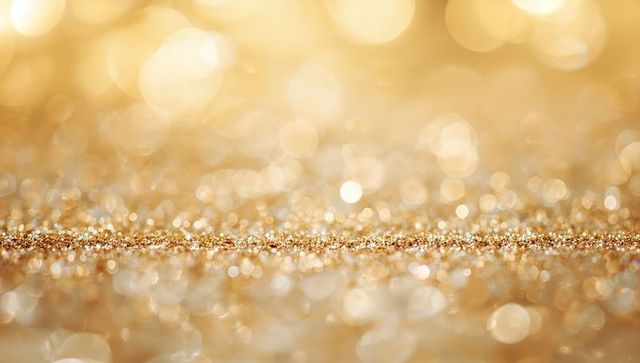 Shimmering golden glitter strip with bokeh sparkle and reflective metallic texture