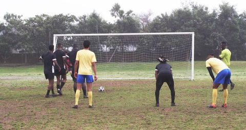 Diverse Soccer Players Preparing for Successful Free Kick