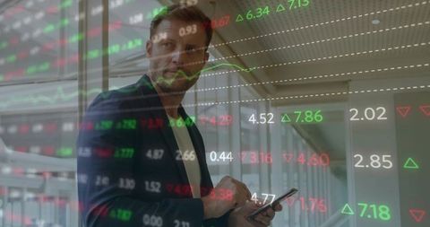 Businessman Analyzing Stock Data with Graphs Overlaid