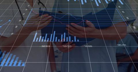 Healthcare professionals analyzing digital charts in corridor