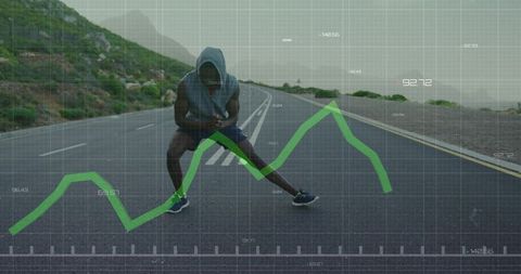 Hooded runner stretching on coastal road with fitness analytics overlay and smartphone