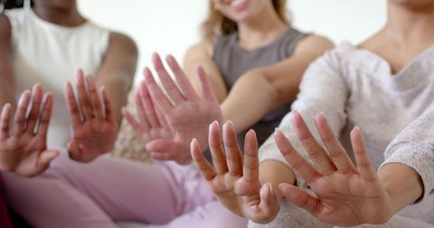 African american women holding palms forward showing stop gesture while smiling together