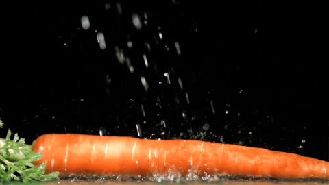 Fresh Carrot Wet in Pearled Water Against Dark Backdrop