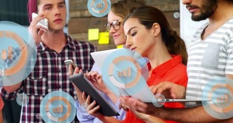 Diverse Colleagues Collaborating with Technology Devices and Digital Icons