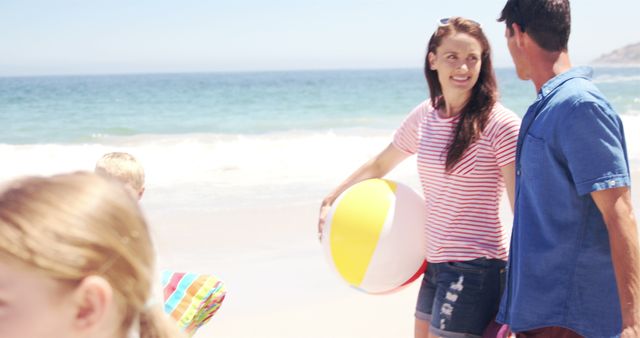 Family Enjoying Beach Day with Beach Ball and Towels - Download Free Stock Images Pikwizard.com