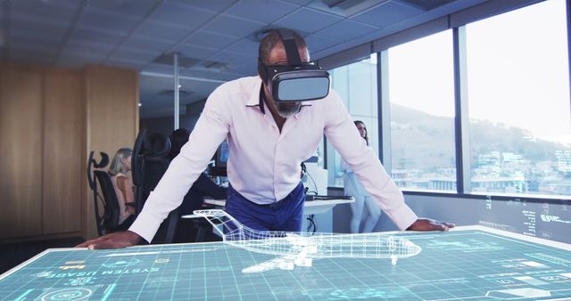 A business man is using VR glasses to preview industrial designs in a modern office environment. The image can be used to illustrate the use of virtual reality and advanced technologies in professional settings, highlighting innovation, productivity, and futuristic workplace solutions.