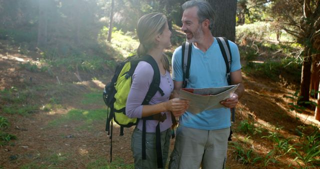 Smiling Couple Hiking in Sunny Forest with Map - Download Free Stock Images Pikwizard.com