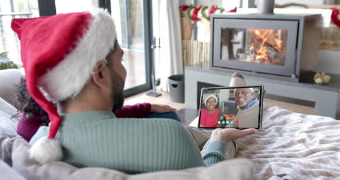 Diverse Family Enjoying Christmas Video Call by Cozy Fireplace