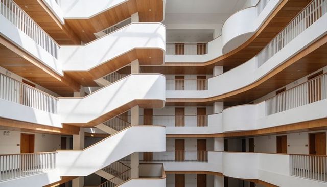 Minimalist hotel atrium with curved balconies, timber ceilings and skylight geometry