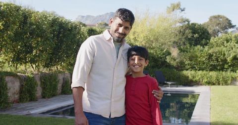 Father and Son Bonding by Pool in Serene Backyard