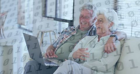 Happy Senior Couple Navigating Laptop with Binary Code Overlay