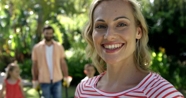 Smiling Woman Enjoying Day with Family in Park - Download Free Stock Images Pikwizard.com