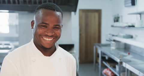 Smiling Chef in Kitchen Illustrates Culinary Passion