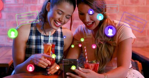 Happy Female Friends Enjoying Cocktails with Social Media Icons