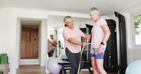 Senior couple measuring waist during home fitness session