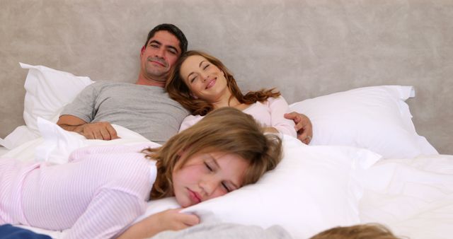 Happy Family Relaxing in Bed with Children Sleeping - Download Free Stock Images Pikwizard.com