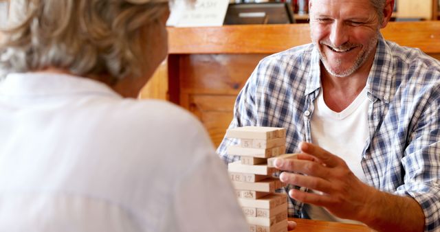 Friends Playing Wooden Block Game at Table - Download Free Stock Images Pikwizard.com