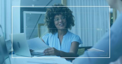 Businesswoman Discussing Documents in Modern Office Meeting