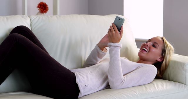 Woman Relaxing on Sofa while Using Smartphone Indoors - Download Free Stock Images Pikwizard.com