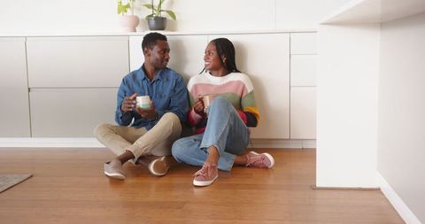 Couple Discussing Over Drinks in Contemporary Kitchen