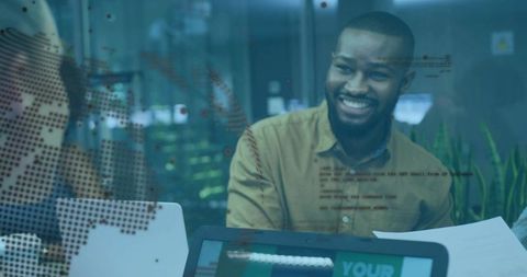 Smiling man leading collaborative meeting in office with glass partition and map overlay