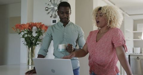Friends Engaging and Conversing Over Laptop at Home